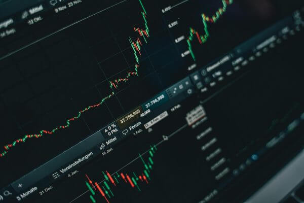 A close-up of a computer screen displaying multiple financial charts and stock market data, showcasing candlestick graphs and numerical values—essential tools for any Financial Planner at Pinsker Wealth.